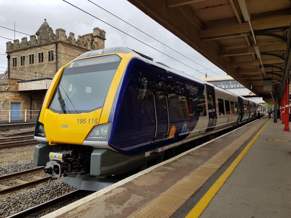 Northern train number 195116, named 'Proud to be Northern', in  the platform at Lancaster bound for Manchester Airport